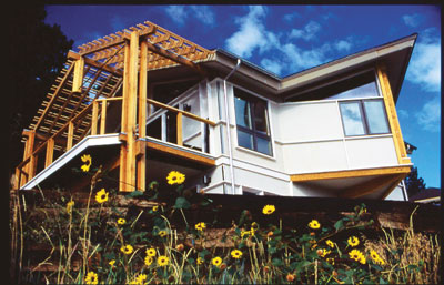 When David Johnston added an office to his home, the eco-remodel included structural insulated panels, engineered wood for all large structural beams, durable fiber cement siding, large overhangs to protect the siding from moisture, recycled plastic decking, low-E windows, a ceiling fan, plenty of natural daylight, and Interface carpet.
